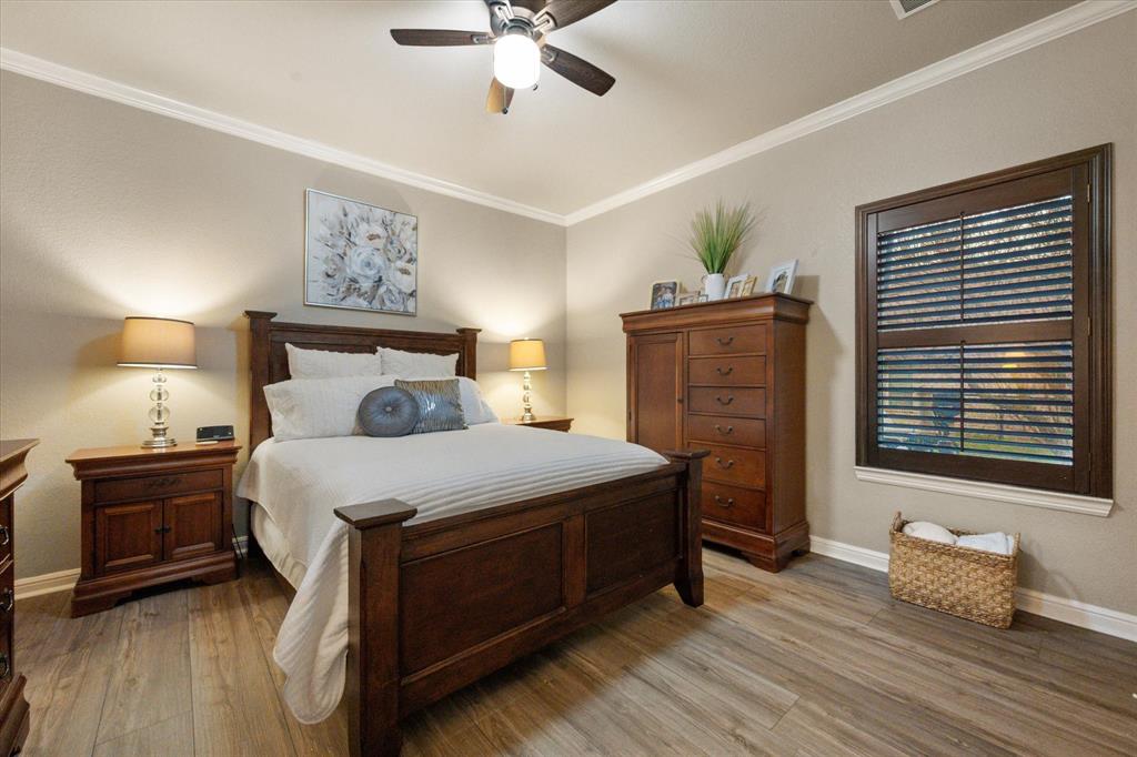 3715 Lonesome Creek Road Granbury, TX 76049 - Photo 32 of 40 a bedroom with a bed and wooden floor