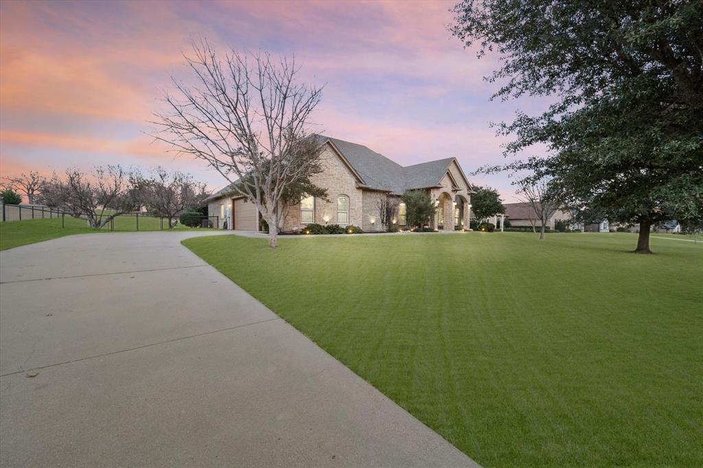 3715 Lonesome Creek Road Granbury, TX 76049 - Photo 8 of 40 a view of a big house with a big yard and large trees