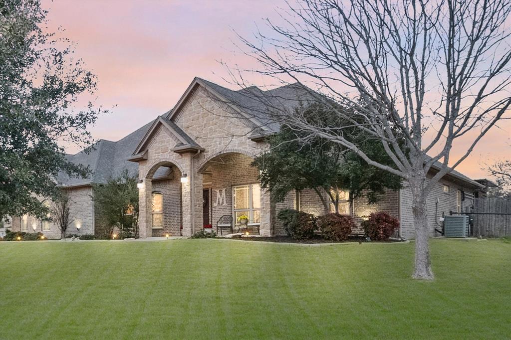 3715 Lonesome Creek Road Granbury, TX 76049 - Photo 9 of 40 a front view of a house with a garden