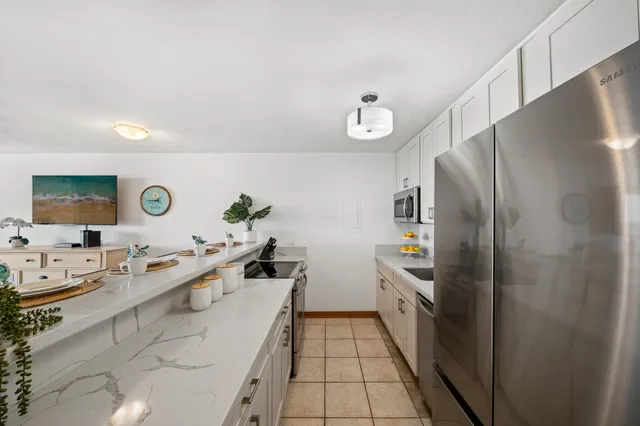 a large kitchen with a large window and stainless steel appliances