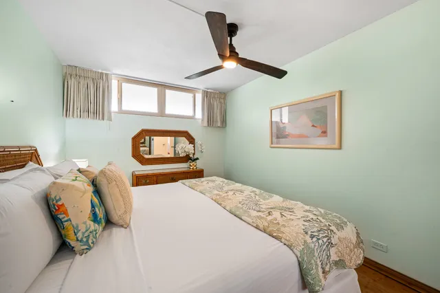 a bedroom with a bed and a painting on the wall