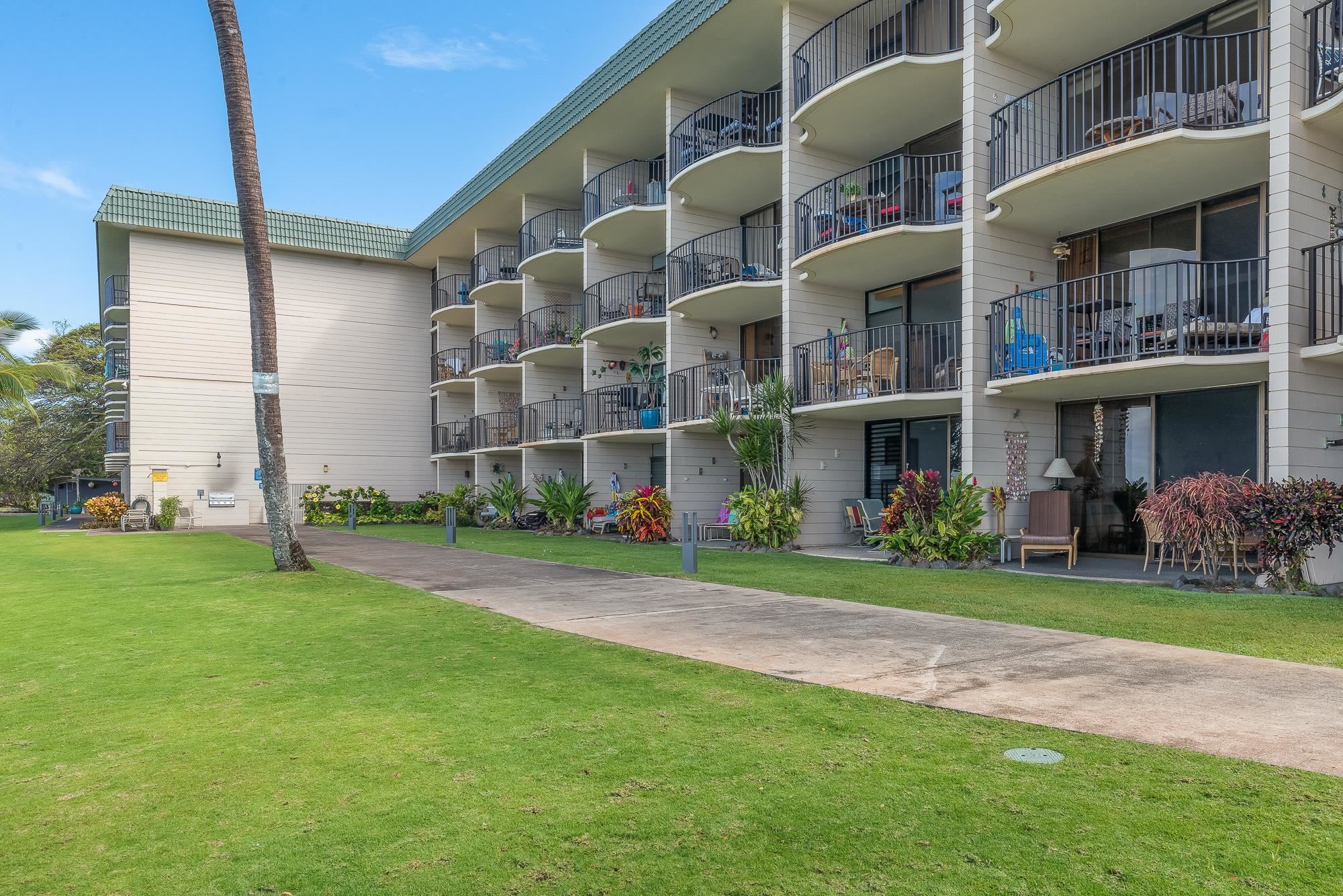 4471 Lower Honoapiilani Road, Unit 203 Lahaina, HI 96761 - Photo 17 of 40 a front view of building with yard