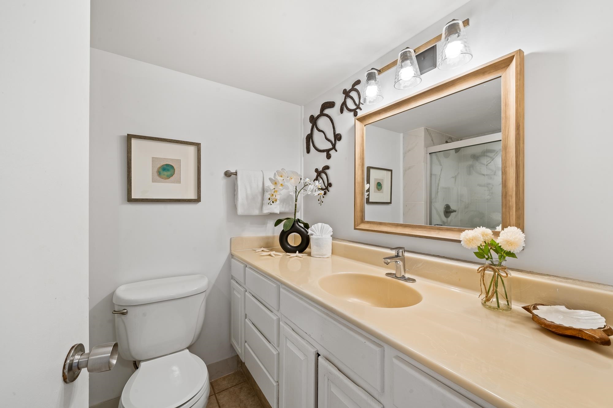 4471 Lower Honoapiilani Road, Unit 203 Lahaina, HI 96761 - Photo 21 of 40 a bathroom with a sink a toilet and mirror