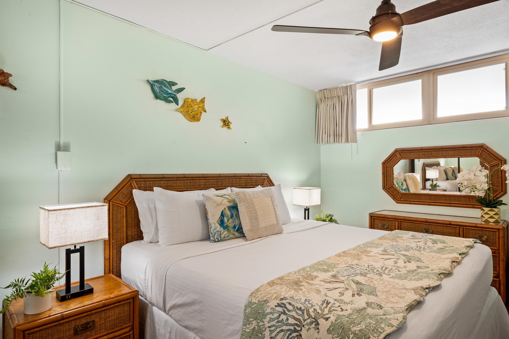 4471 Lower Honoapiilani Road, Unit 203 Lahaina, HI 96761 - Photo 23 of 40 a bedroom with a bed a lamp and a window