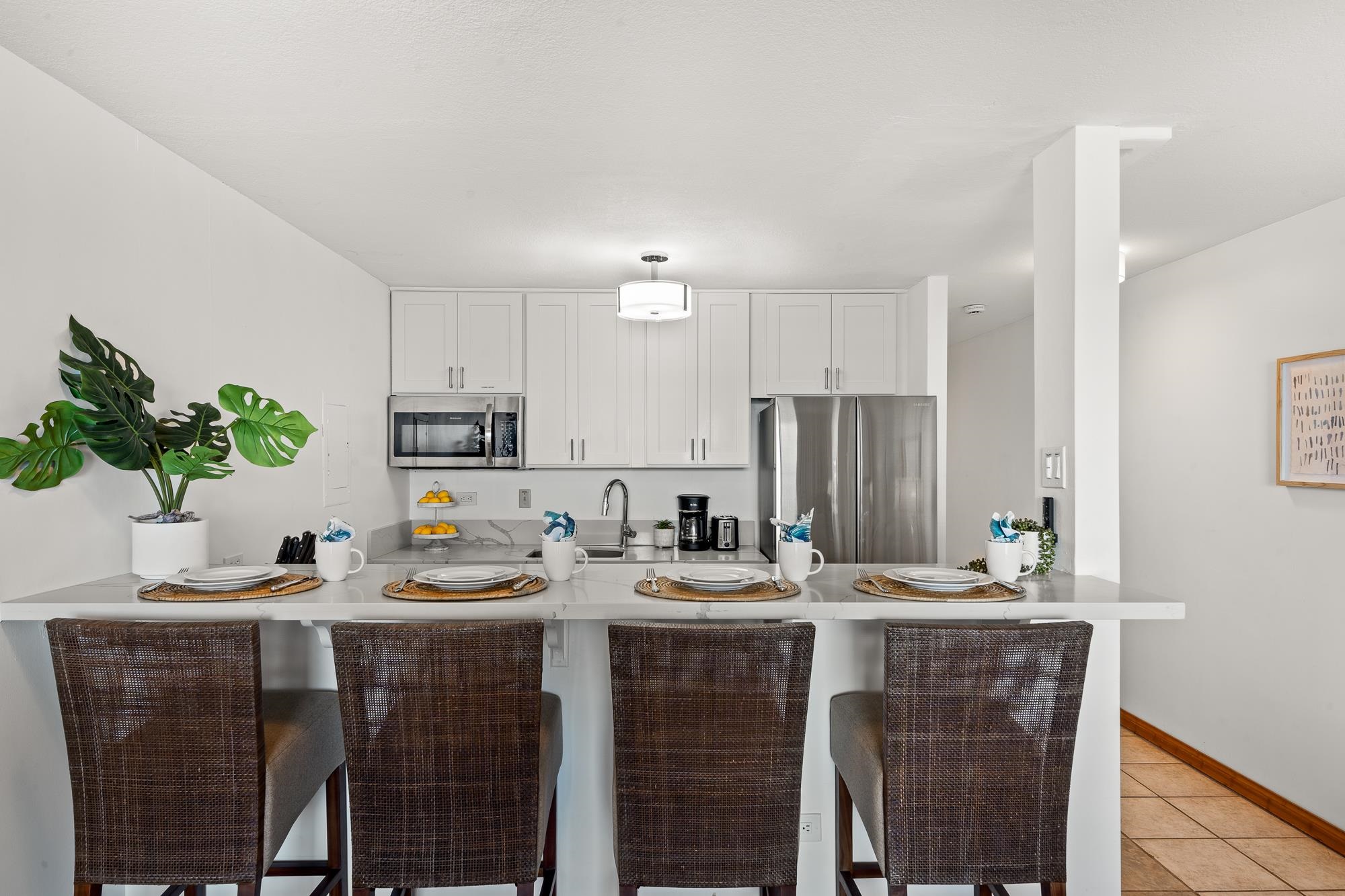 4471 Lower Honoapiilani Road, Unit 203 Lahaina, HI 96761 - Photo 3 of 40 a kitchen with kitchen island granite countertop a sink cabinets and stainless steel appliances