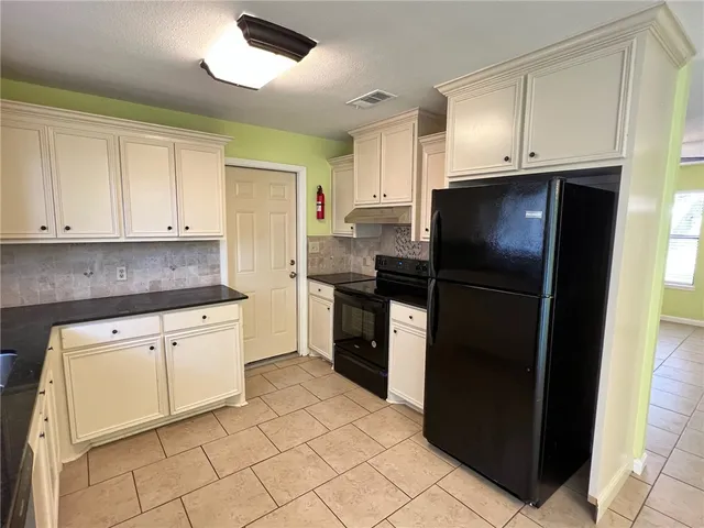 a kitchen with granite countertop cabinets and steel stainless steel appliances