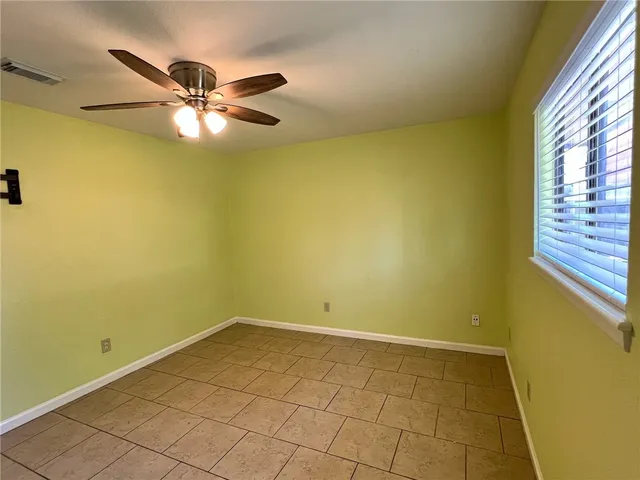 a view of a room with window and a ceiling fan