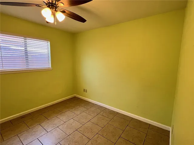 a view of a room with a fan and a window