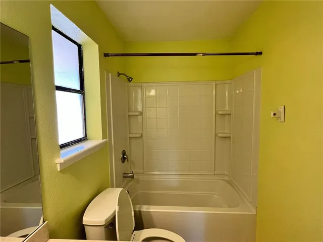 a bathroom with a shower and a sink