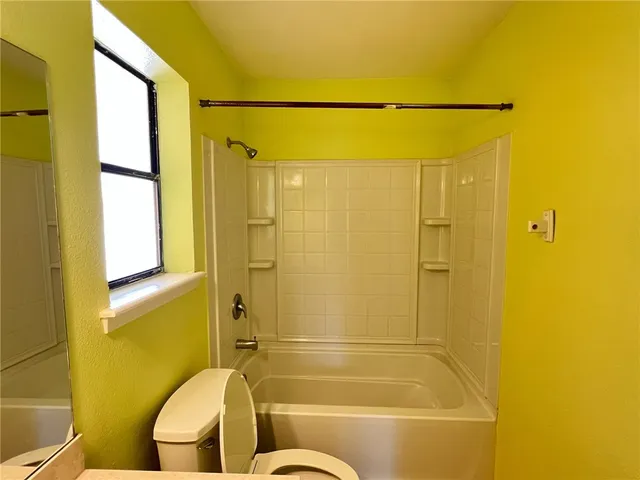 a bathroom with a shower and a toilet