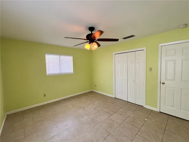 a view of empty room with ceiling fan