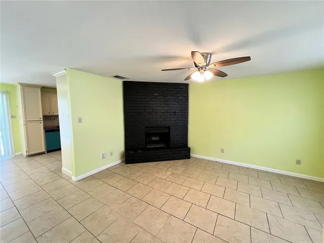 wooden floor in an empty room with a fireplace