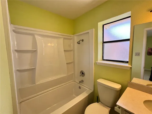 a bathroom with a toilet and a bathtub