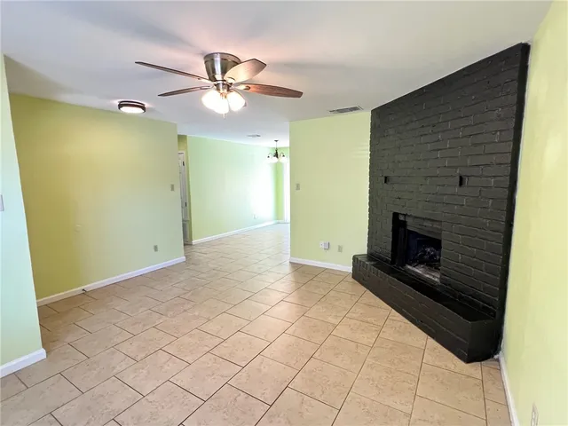a view of an empty room with a fireplace