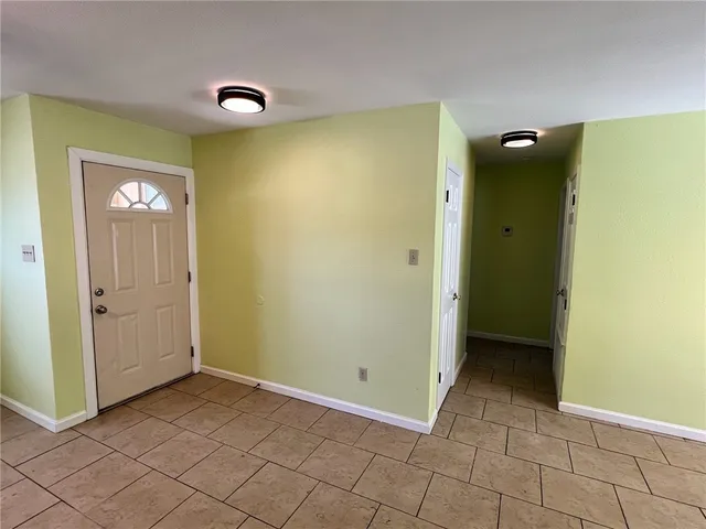 a view of an empty room with windows