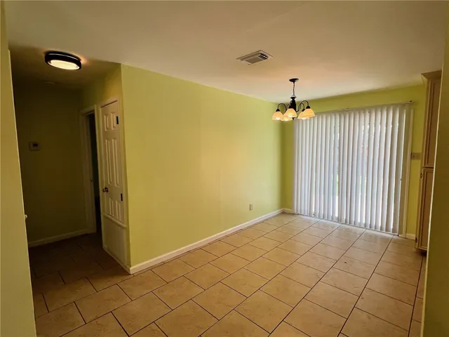 a view of a hallway with a chandelier