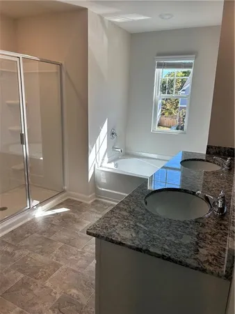 a kitchen with granite countertop a sink a stove and a wooden floor