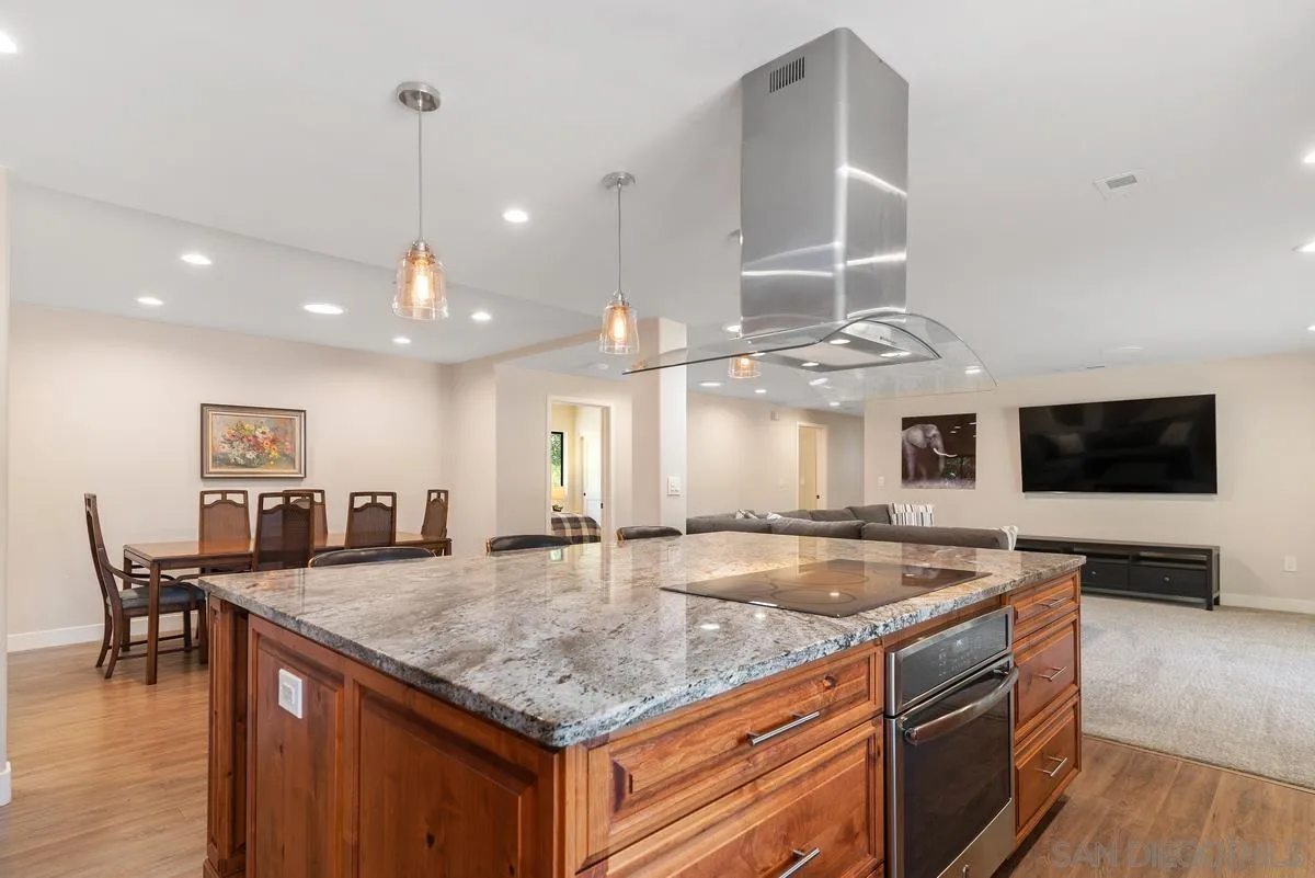 17230 Highway 67 Ramona, CA 92065 - Photo 12 of 37 a kitchen with a stove center island and a wooden floor