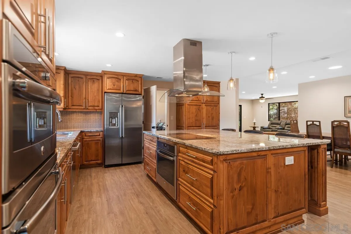 17230 Highway 67 Ramona, CA 92065 - Photo 13 of 37 a kitchen with stainless steel appliances granite countertop a stove and a refrigerator