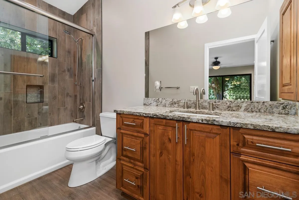 17230 Highway 67 Ramona, CA 92065 - Photo 18 of 37 a bathroom with a granite countertop sink toilet and shower