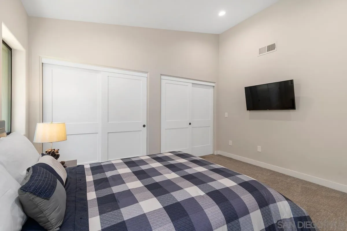 17230 Highway 67 Ramona, CA 92065 - Photo 19 of 37 a bedroom with a bed and a television