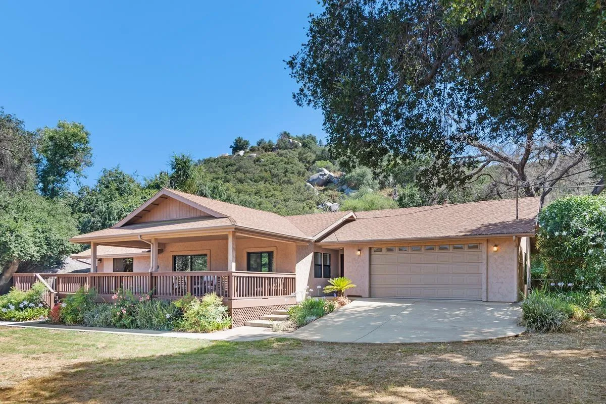 17230 Highway 67 Ramona, CA 92065 - Photo 2 of 37 a front view of a house with a yard and garage