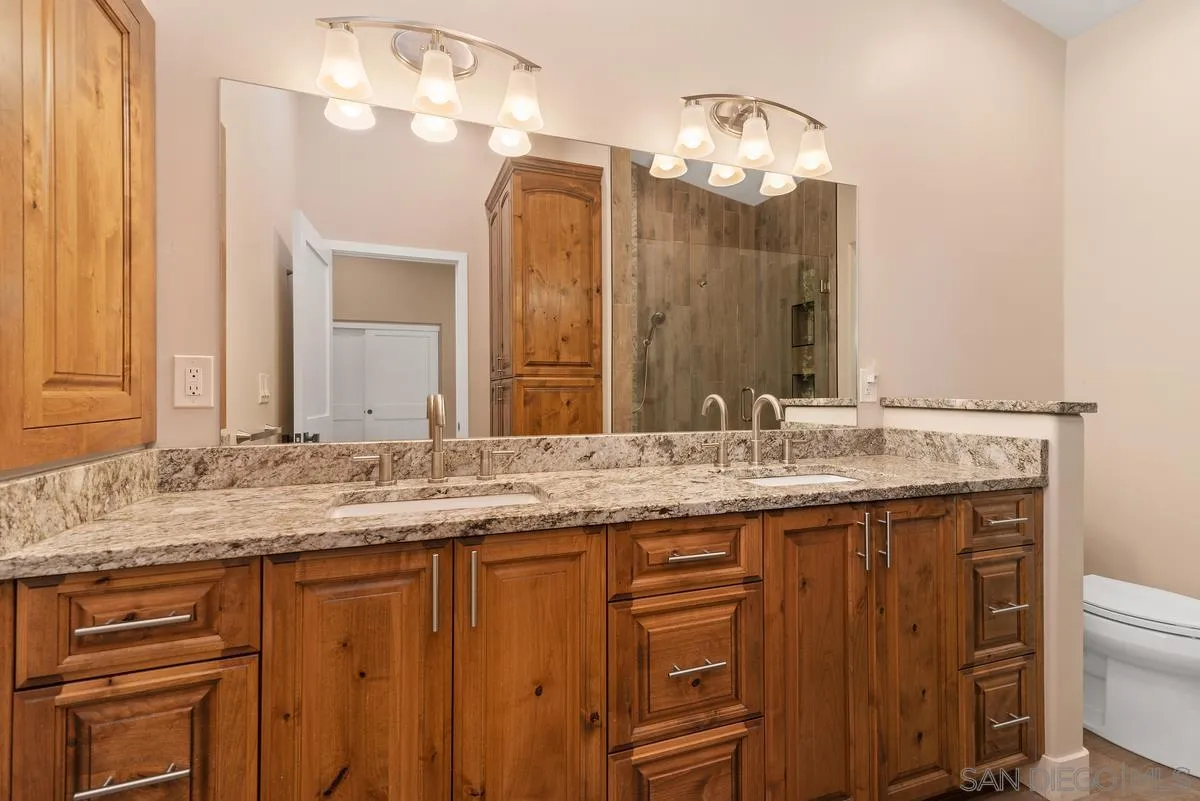 17230 Highway 67 Ramona, CA 92065 - Photo 21 of 37 a bathroom with a granite countertop sink and a mirror