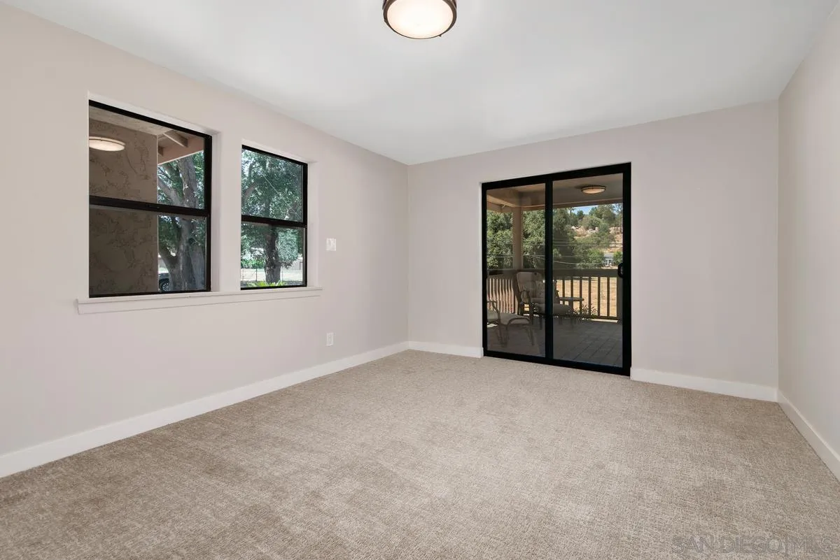 17230 Highway 67 Ramona, CA 92065 - Photo 23 of 37 a view of an empty room with window and wooden floor