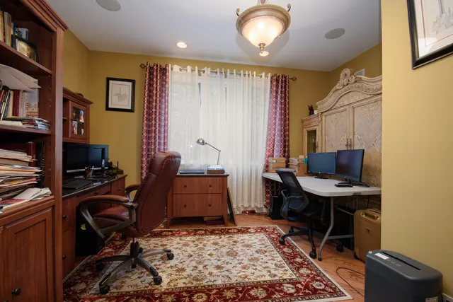a view of a workspace with furniture and a window