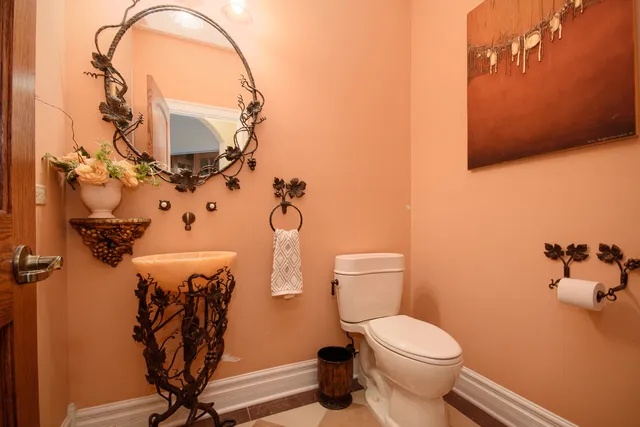 a bathroom with a toilet sink and mirror