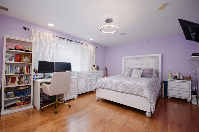 a bedroom with a bed and a book shelf