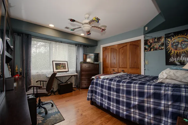 a bedroom with bed and glass windows