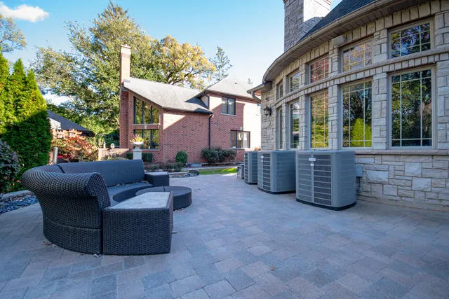 a view of a patio with couches and a fire pit and a barbeque