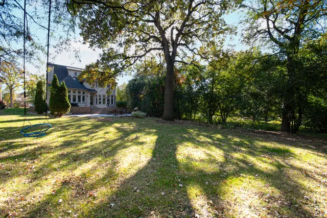 a swimming pool with outdoor seating and yard