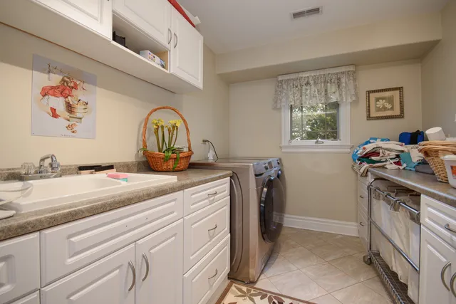 a view of a kitchen with fridge and window