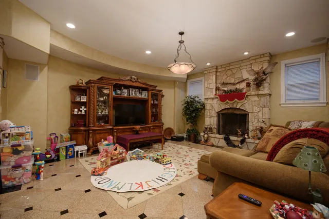 a living room with furniture a fireplace and a flat screen tv
