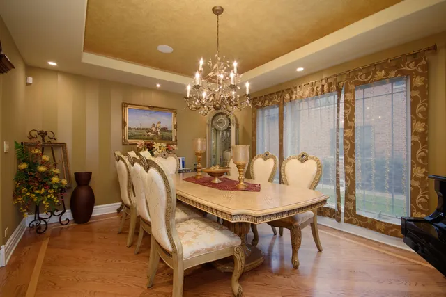 a view of a dining room with furniture and chandelier