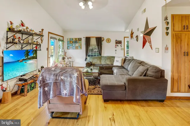 a view of a living room with furniture and a kitchen view