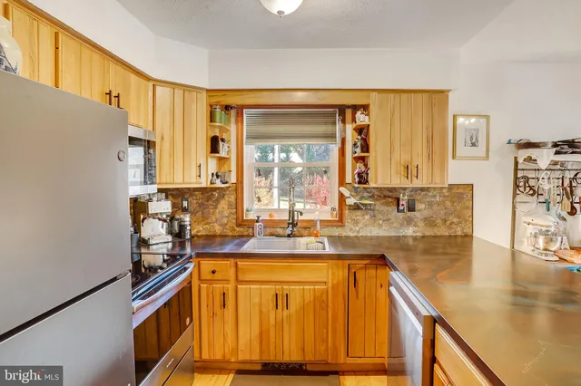 a bedroom with a bed and a computer on a desk