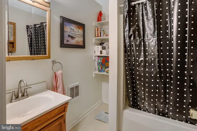 a living room with furniture a window and bookshelf