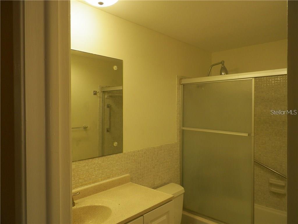 911 Washington Avenue Southwest, Unit 304 Largo, FL 33770 - Photo 21 of 26 a bathroom with a sink and a shower