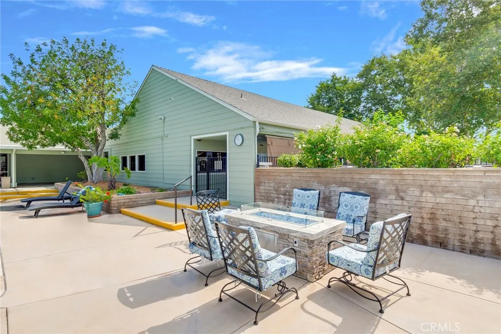 4000 Pierce Street, Unit 220 Riverside, CA 92505 - Photo 29 of 30 a view of a patio with table and chairs under an umbrella