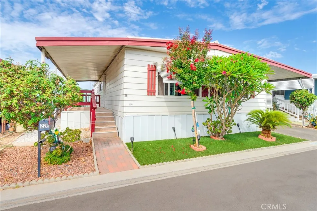 4000 Pierce Street, Unit 220 Riverside, CA 92505 - Photo 3 of 30 a front view of a house with a yard and a garage