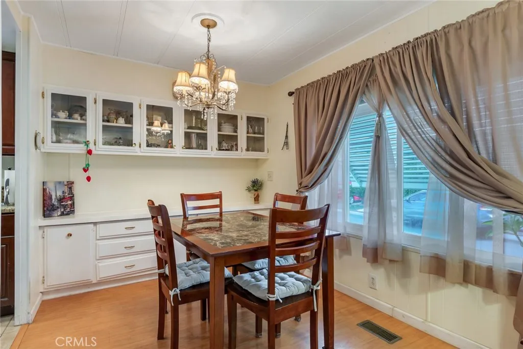 4000 Pierce Street, Unit 220 Riverside, CA 92505 - Photo 8 of 30 a view of a dining room with furniture and chandelier