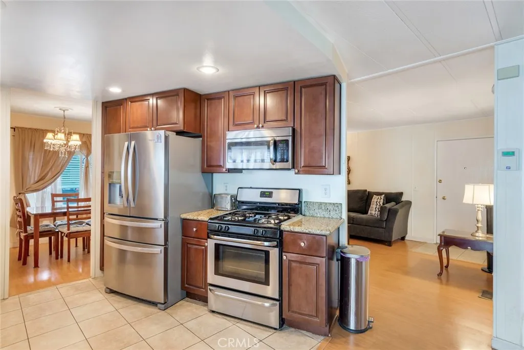 4000 Pierce Street, Unit 220 Riverside, CA 92505 - Photo 10 of 30 a kitchen with stainless steel appliances granite countertop a refrigerator stove and sink