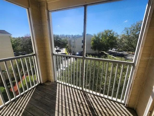 a view of balcony with a floor to ceiling window and wooden floor