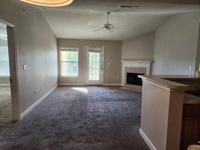 a view of empty room with a fireplace