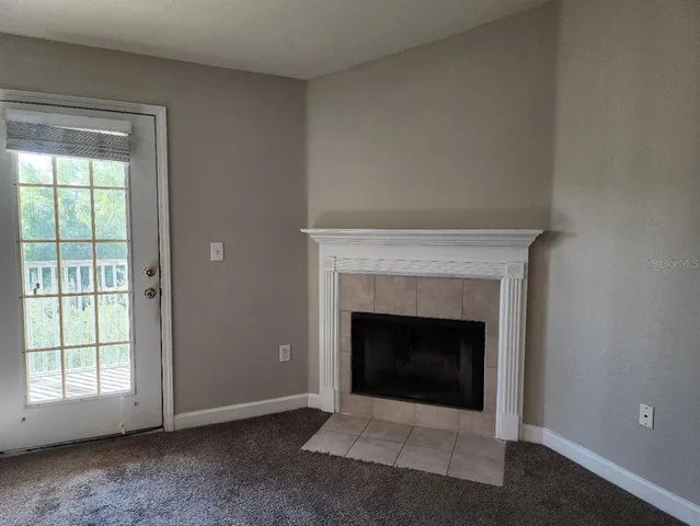 a living room with a fireplace and a window