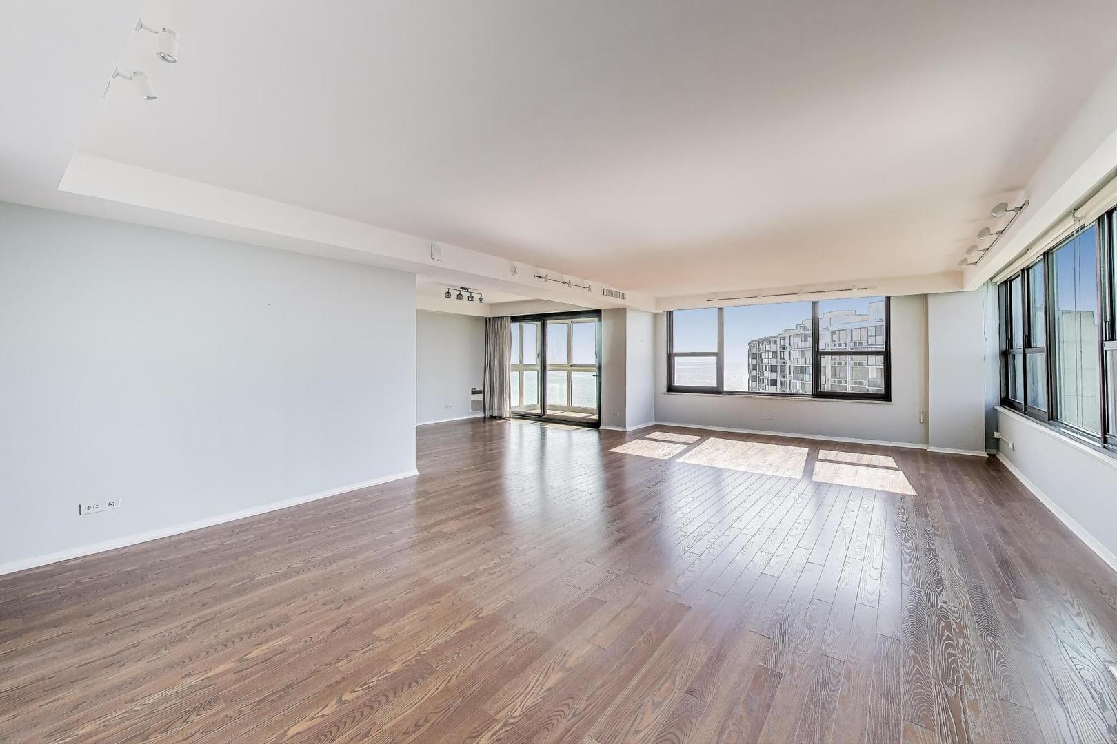 1616 Sheridan Road, Unit 9H Wilmette, IL 60091 - Photo 4 of 28 a view of an empty room with window and wooden floor