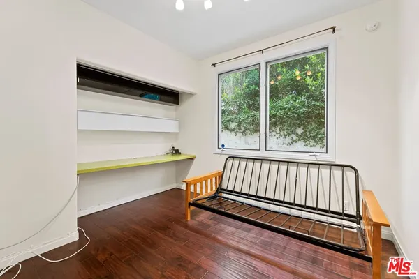 a view of a room with wooden floor and a window